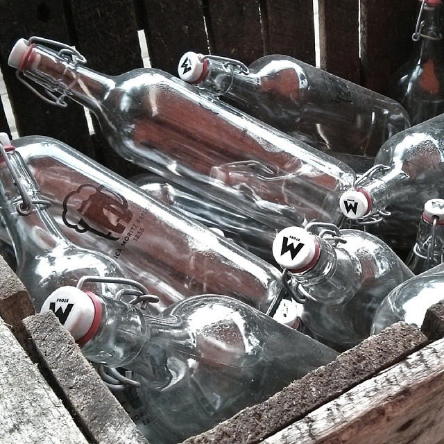 bottles of water sit in a wooden crate