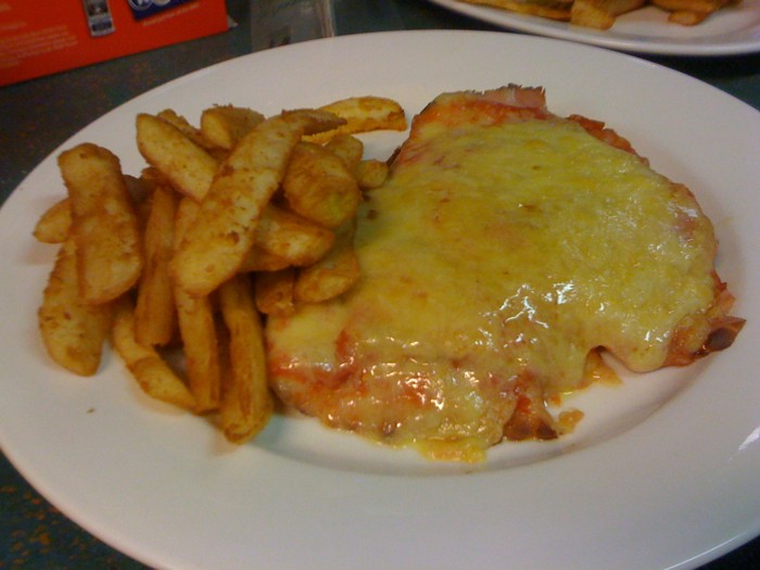a plate with a cheesy lasagna and fries