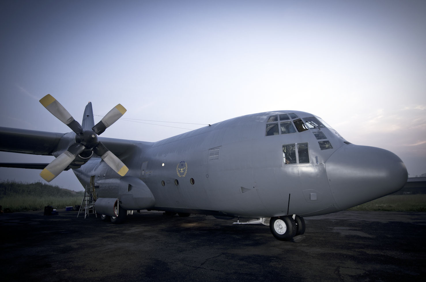 a large airplane with propellers is sitting on the tarmac