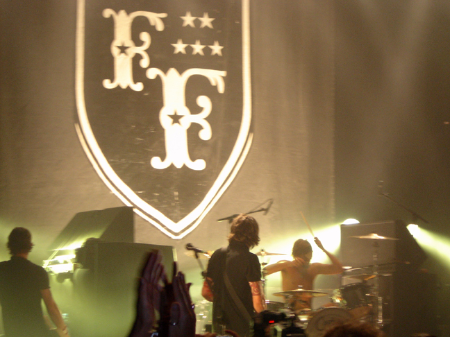 the band perform on stage at the concert