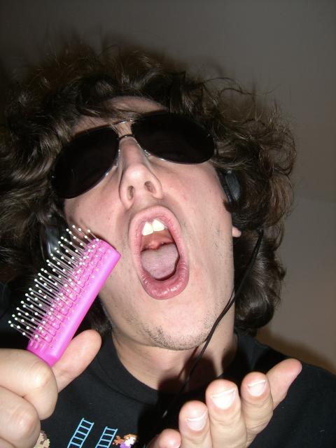 a person with sunglasses and a comb in their hand