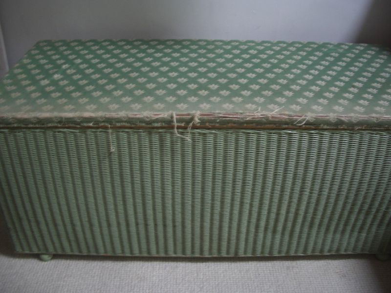 a wicker chest with an odd pattern on the lid