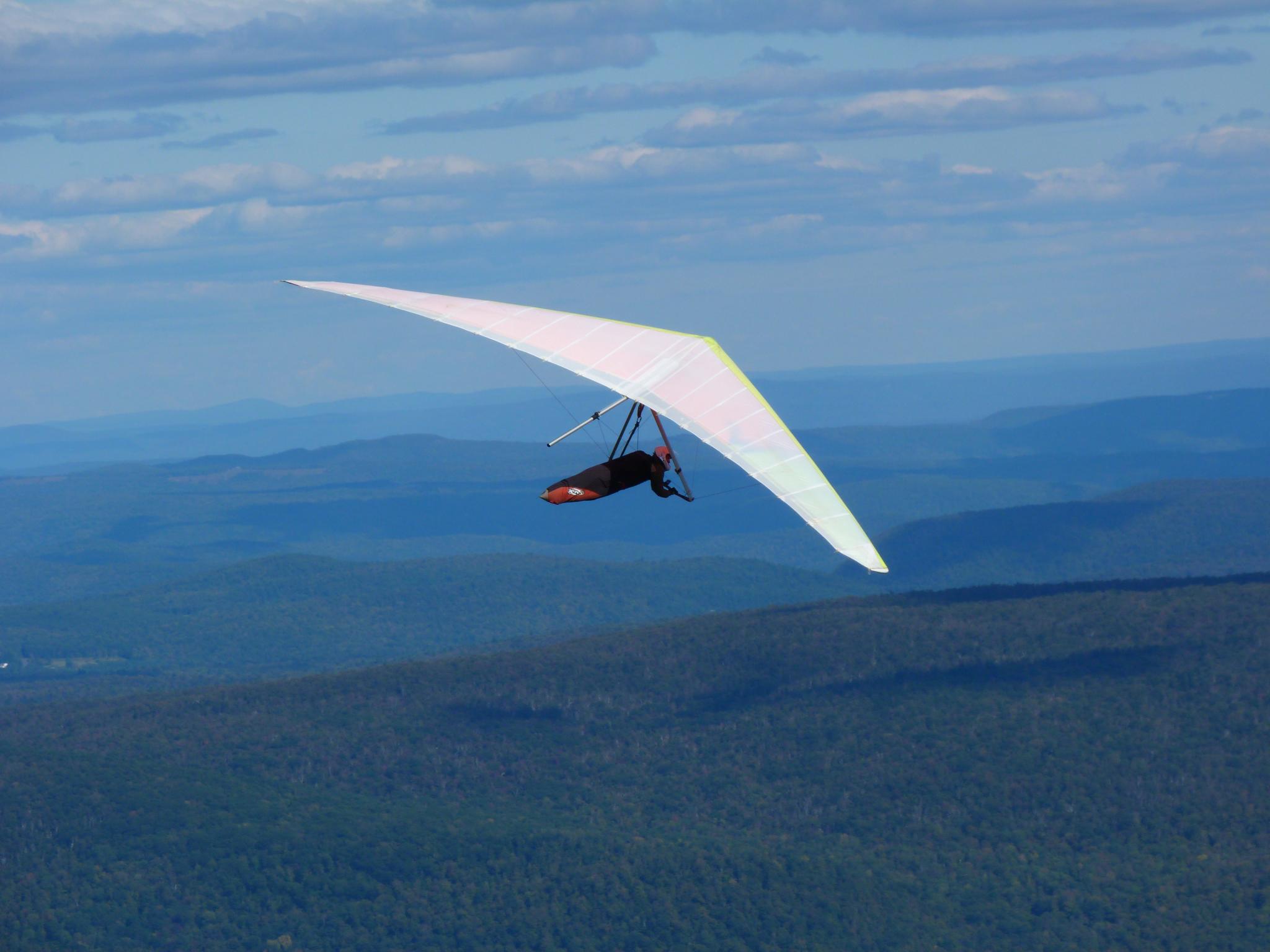 a man falling off of his parachute while parasailing