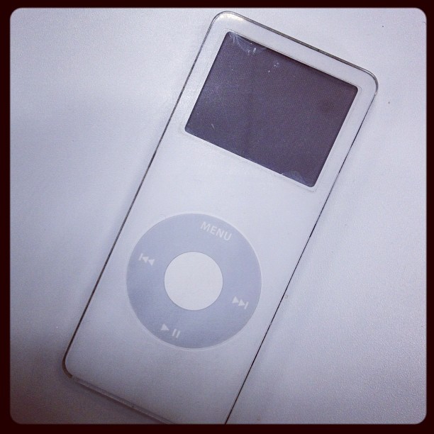 an ipod on a table with its case partially empty