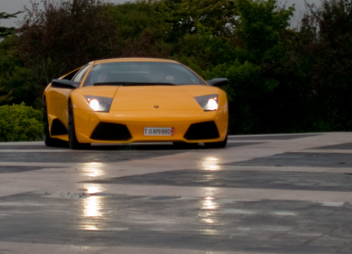 a very nice yellow lamb sport car on the road