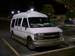 a white van is parked in a parking lot