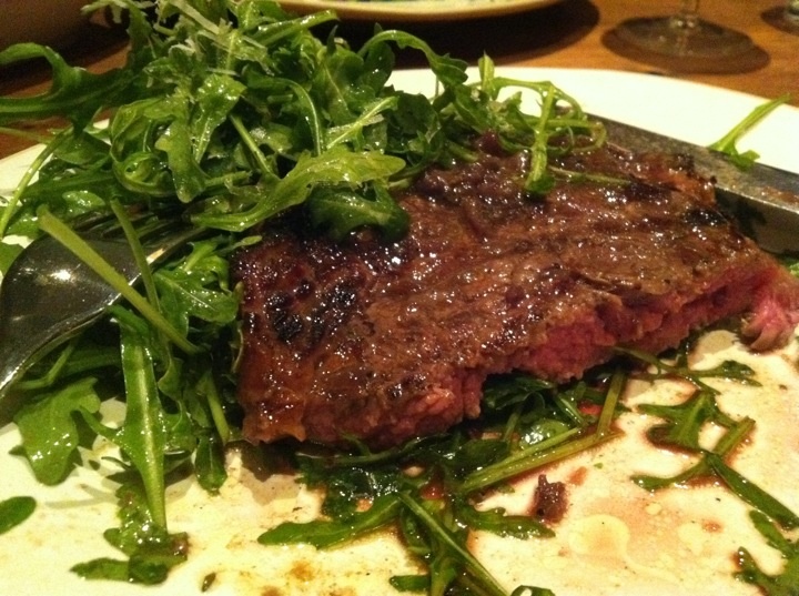 steak with salad and herbs on a plate