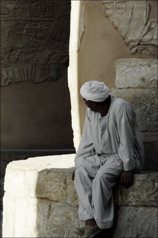 a man sitting on some type of stone