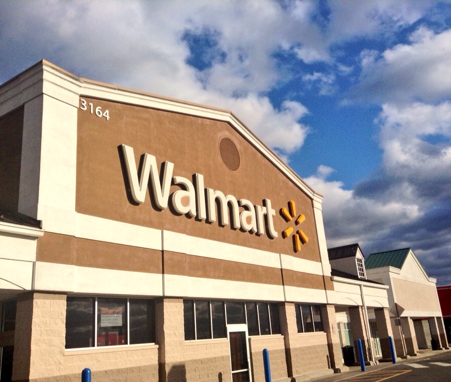 the exterior of a walmart store with clouds in the sky