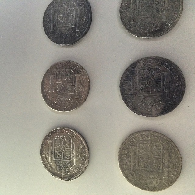 some foreign coins are seen on a surface