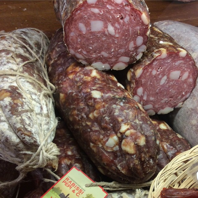assorted salami and meat on display for sale