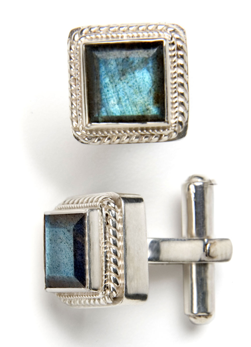 the cufflinks are decorated with silver colored stones