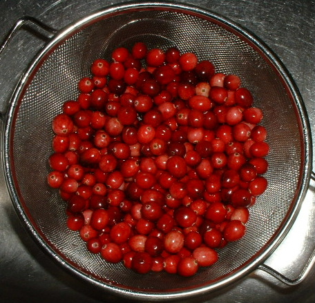 small fruits are being mixed in the strainer