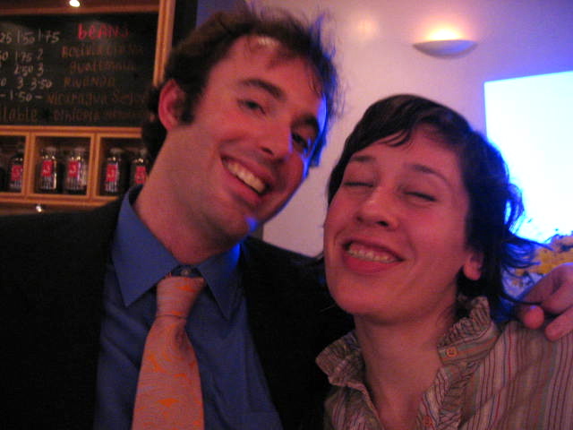 man and woman laughing and posing for a picture
