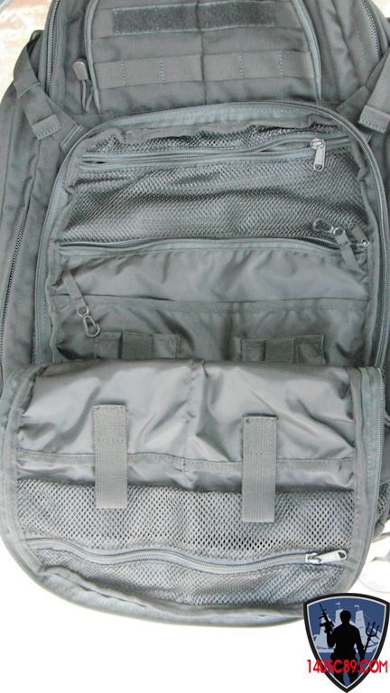 an open backpack sitting on the ground