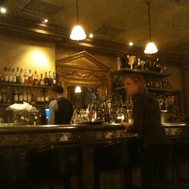 an image of a bar scene with a man behind the bar