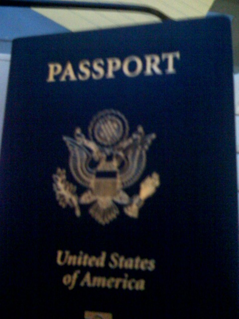 a passport with a flag and coat of arms on it