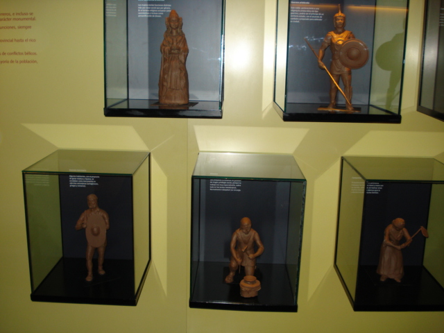 some glass cases with little clay figures in them