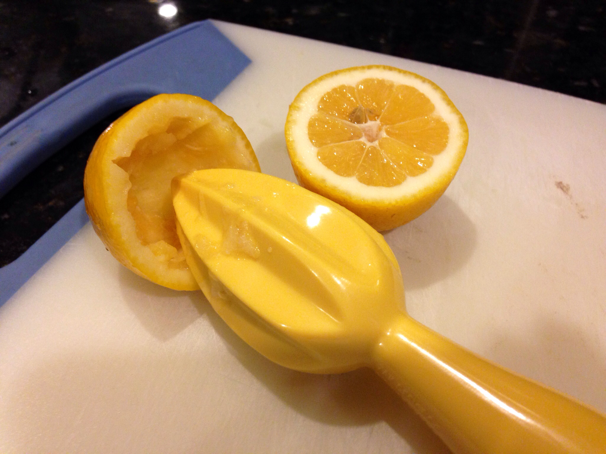a cut up lemon sits on top of a  board