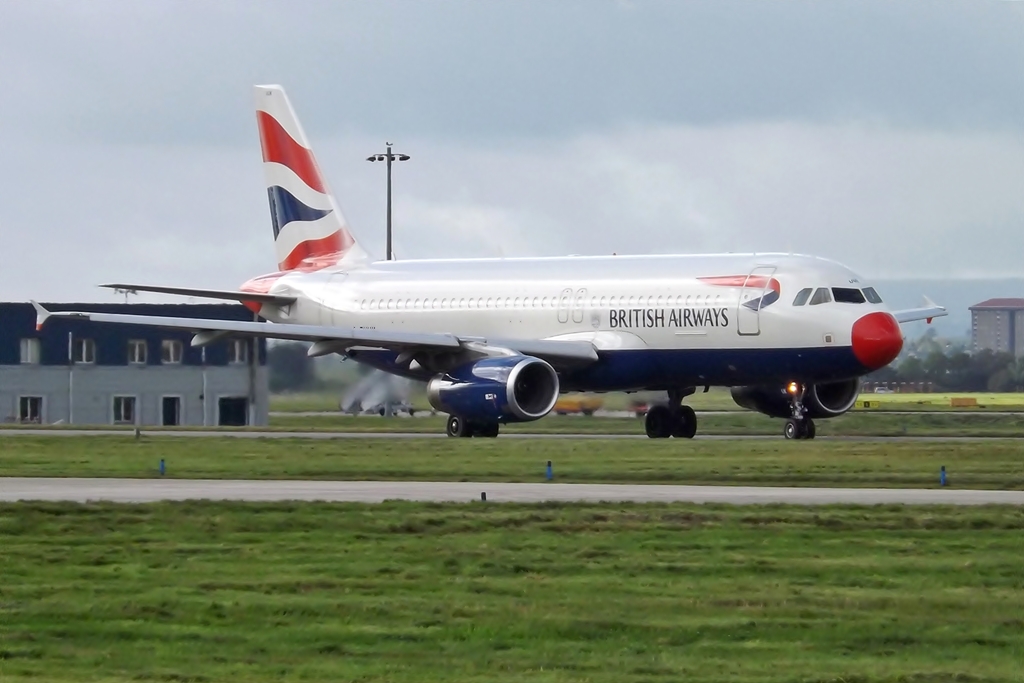 a plane that is on the ground near some grass