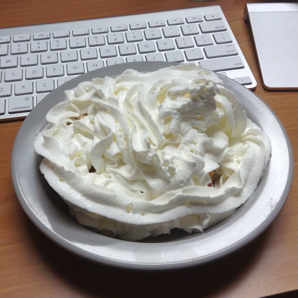 a very tasty looking cake on a plate by the keyboard