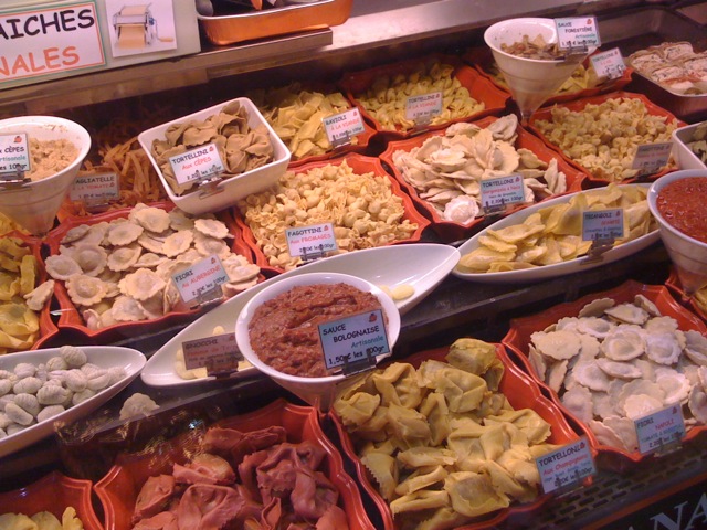 the display case of a deli with various foods
