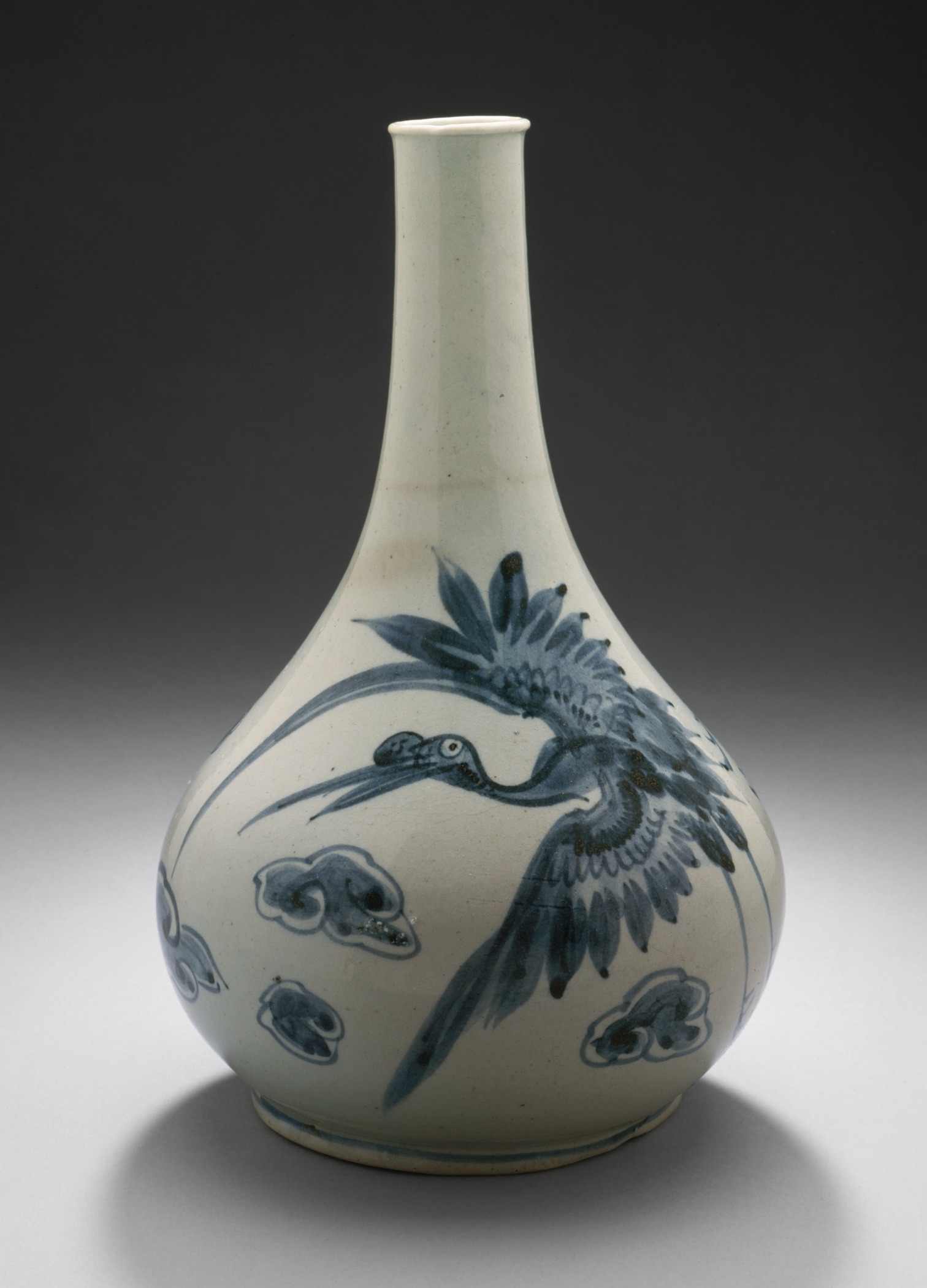a blue and white vase with designs of birds