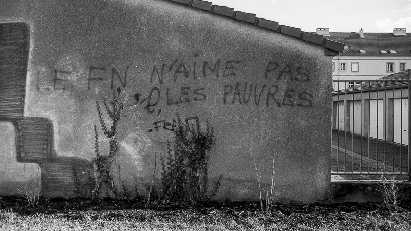 black and white pograph of graffiti writing on a wall