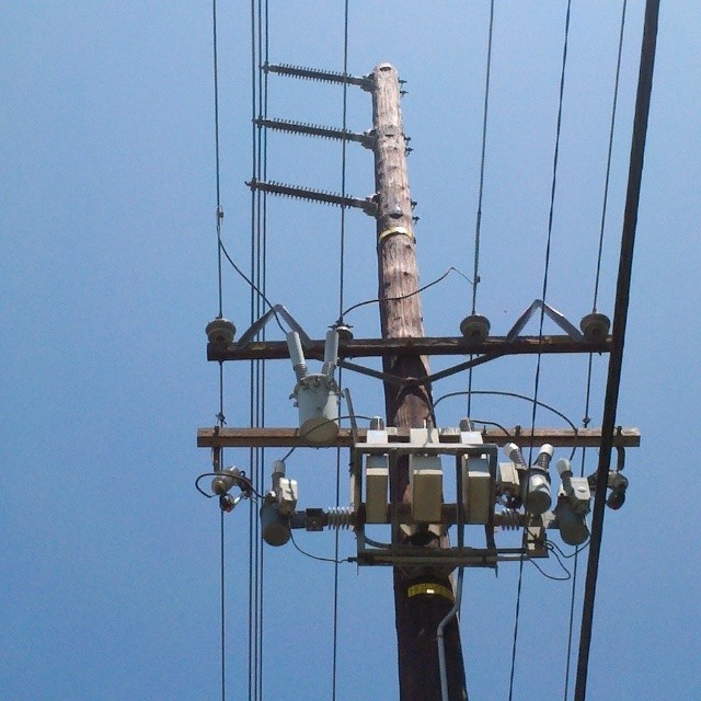 electric pole and power lines with blue sky