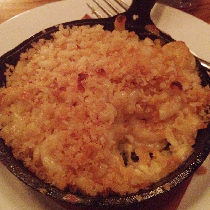 a large plate of food sits on a wooden table