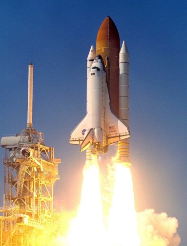 space shuttle taking off from launch pad