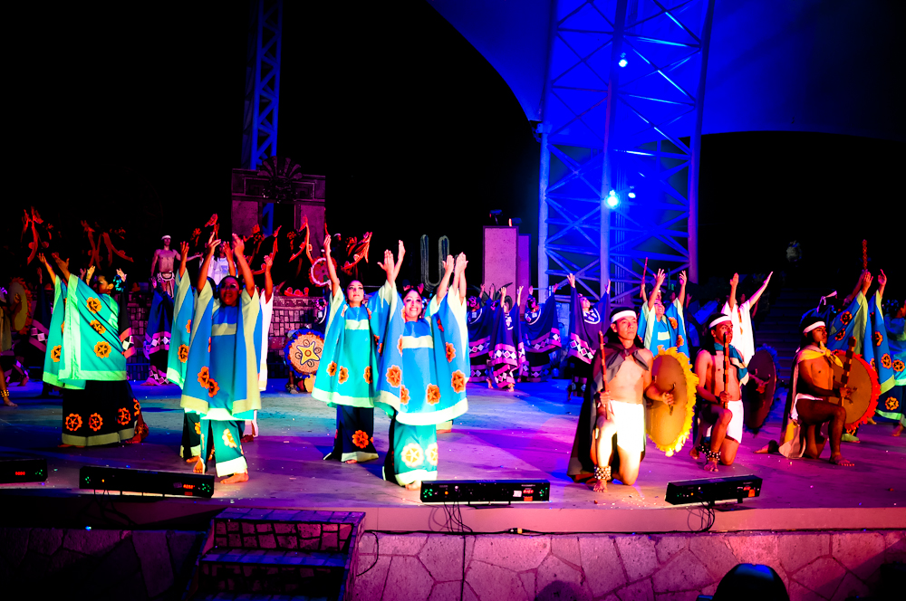 people dressed in costumes are performing with hands up