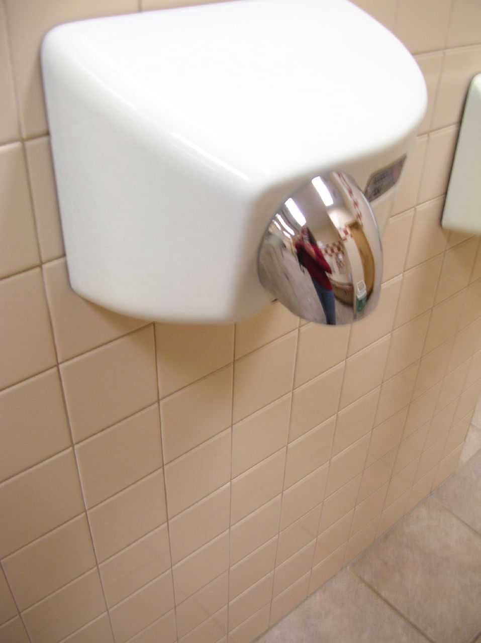 a view of the front of a white urinal