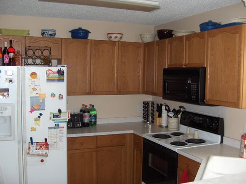 a kitchen with a white refrigerator freezer and oven
