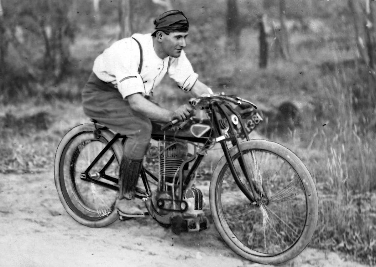an old time po shows a man riding a bicycle