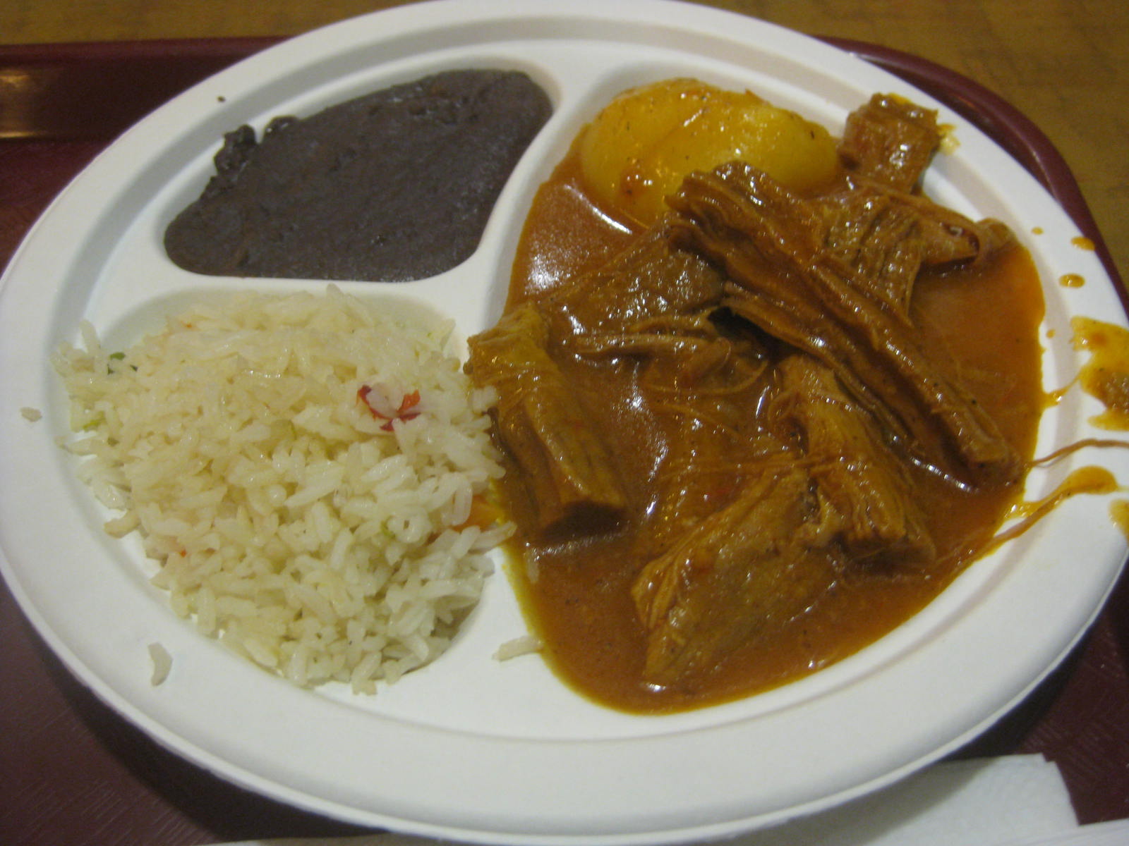 meat, rice, and curry are served on a plate