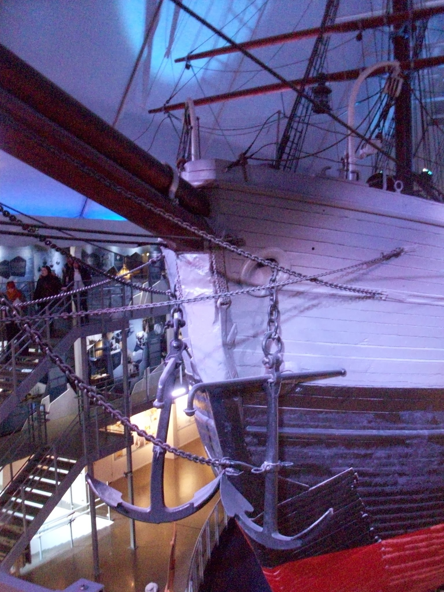 an exhibit with a large boat in the background