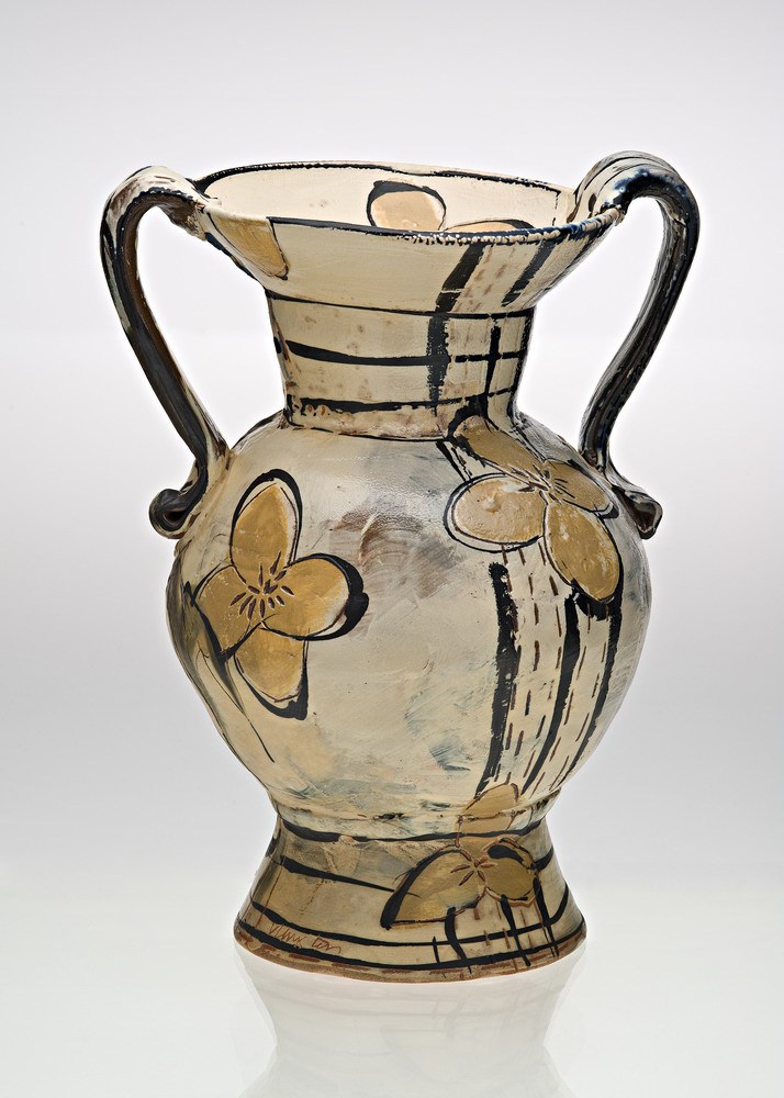 a decorative white and brown vase on white background