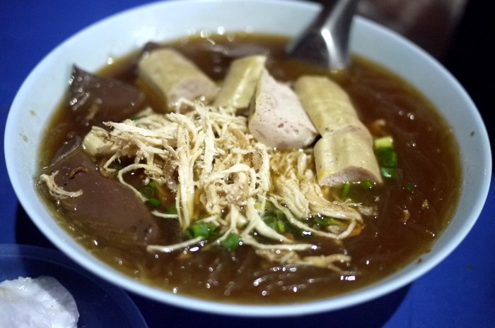 a bowl of soup with noodles, meat, and vegetables