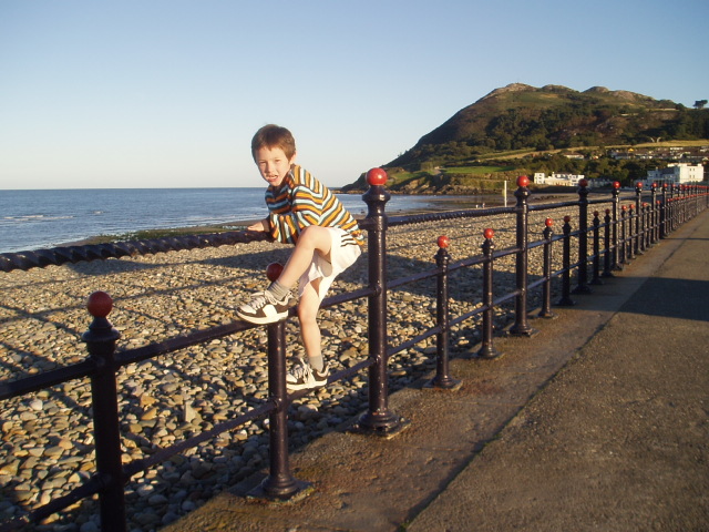 the boy is riding a skateboard on the railing