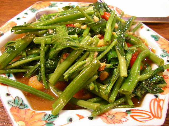 a white bowl filled with greens and beans
