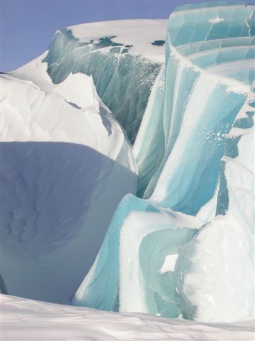 blue icebergs, with mountains in the background
