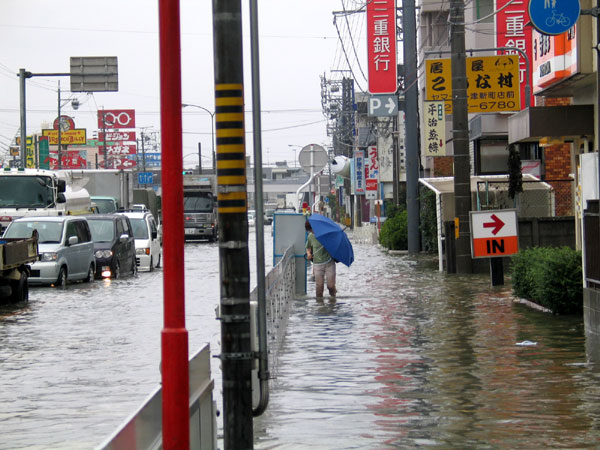 the flooded street has signs and businesses on it
