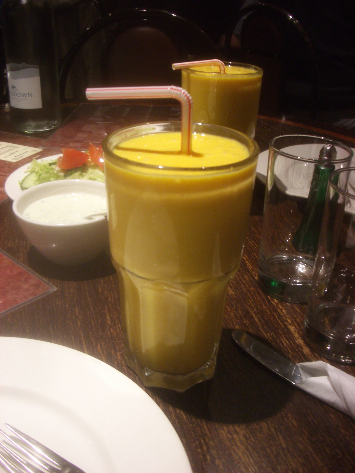 some glasses with juice are sitting on a table