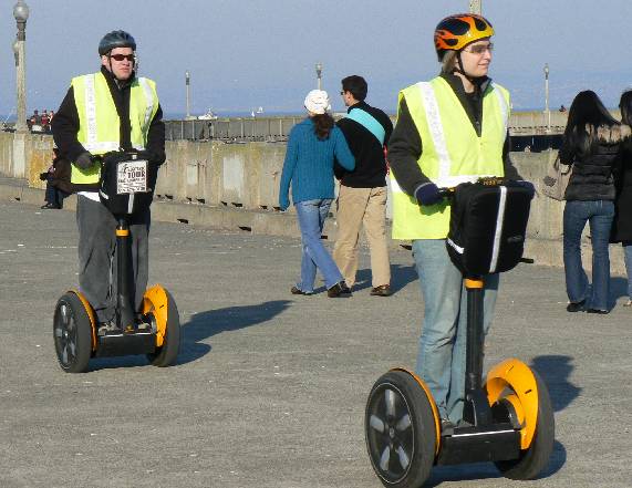 two men on segways ride side by side