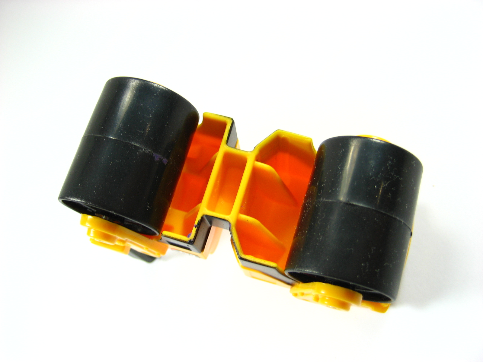 two black, plastic tubes with orange tops