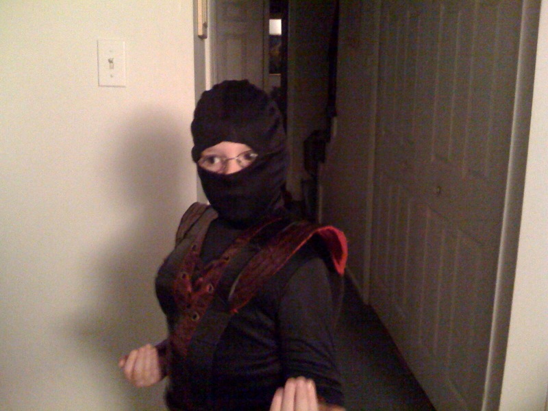 a woman with her head covered in a black mask