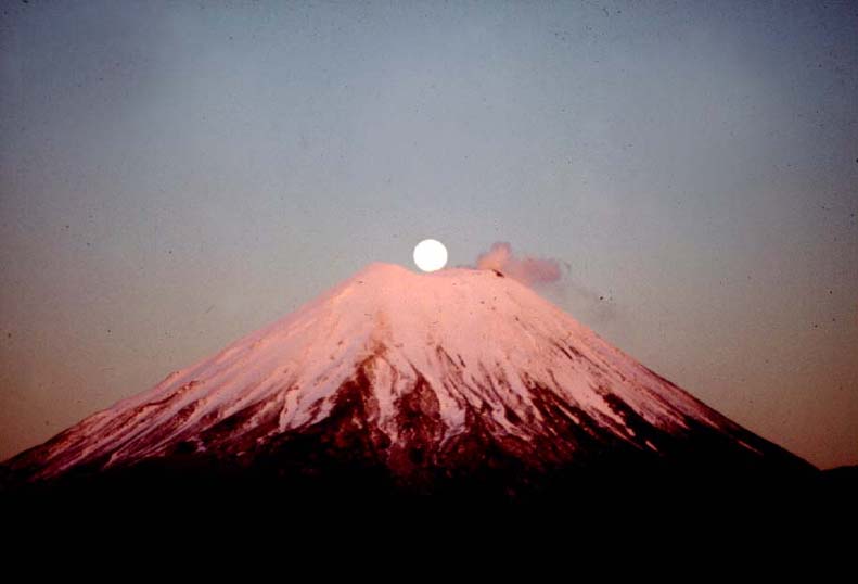 this is the setting sun over a mountain peak