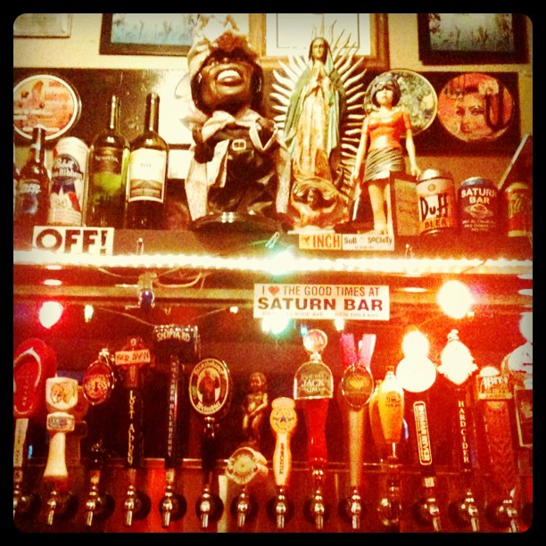a wall of different types of beer taps