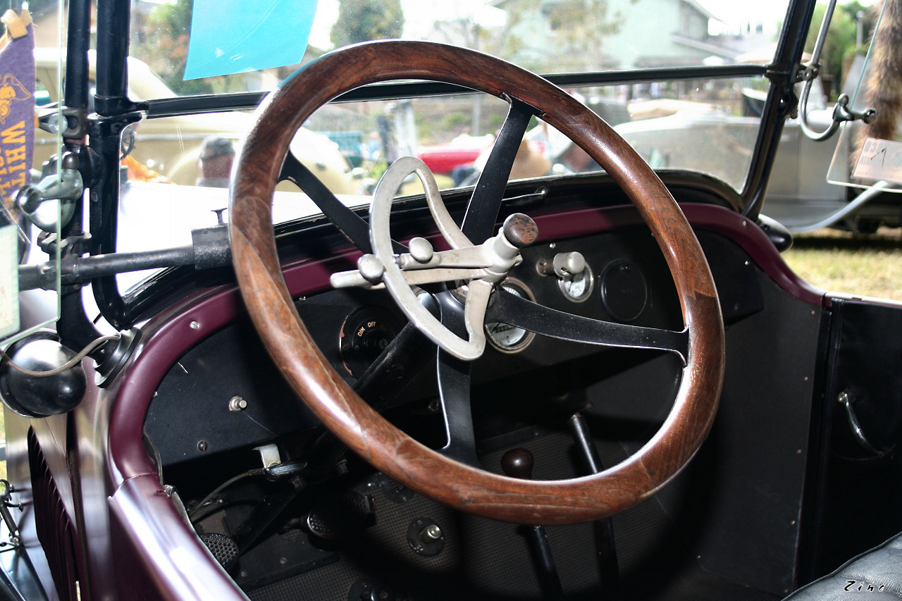 a steering wheel and spokes on a classic vehicle